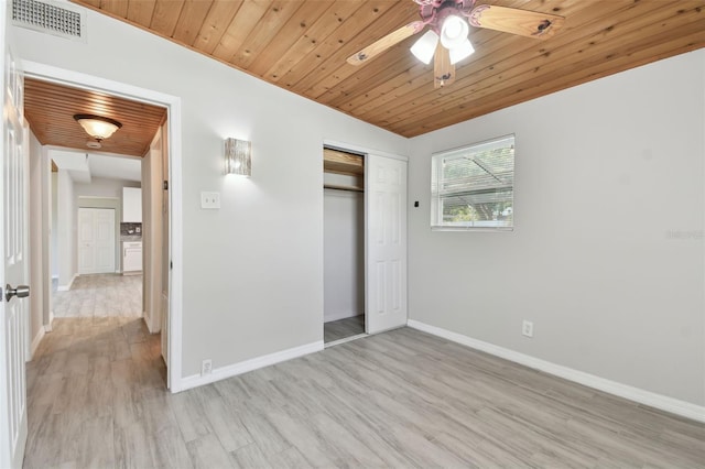 unfurnished bedroom featuring light wood-style floors, wooden ceiling, visible vents, and baseboards