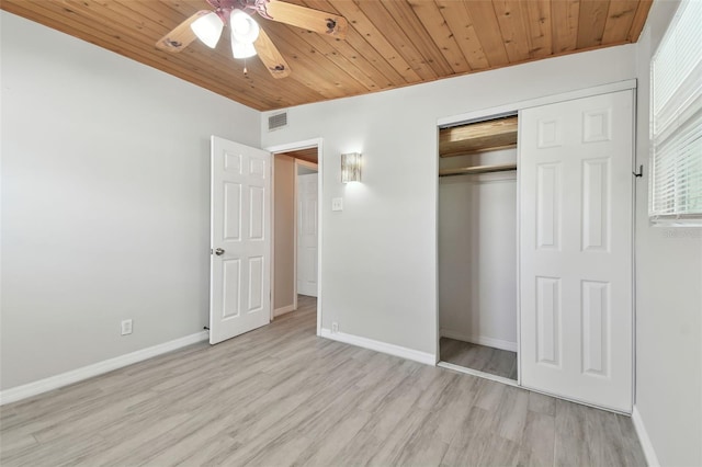 unfurnished bedroom with baseboards, visible vents, wood ceiling, wood finished floors, and a closet