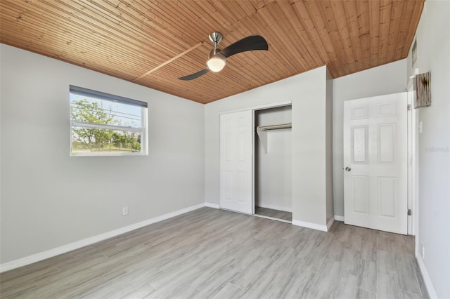 unfurnished bedroom with wooden ceiling, a closet, baseboards, and wood finished floors