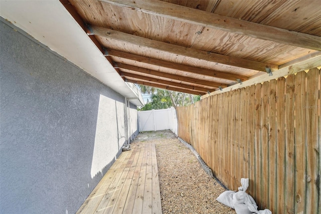 view of side of home featuring fence and stucco siding