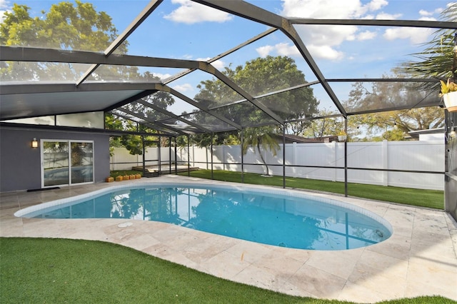 view of swimming pool featuring a patio, glass enclosure, a fenced backyard, a lawn, and a fenced in pool