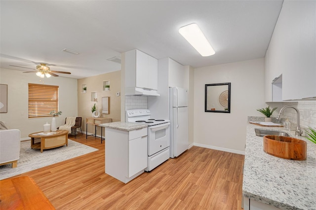 kitchen with under cabinet range hood, white appliances, a sink, white cabinetry, and backsplash