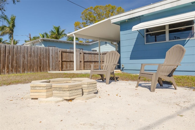 exterior space with fence and a fire pit