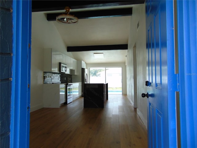 hall with wood finished floors, beam ceiling, and baseboards