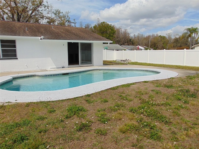 view of swimming pool with a lawn, fence, a fenced in pool, and a patio