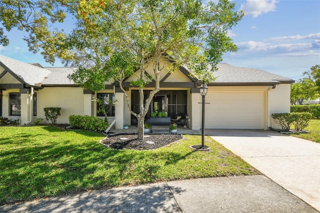 ranch-style home featuring a shingled roof, stucco siding, a front lawn, concrete driveway, and a garage