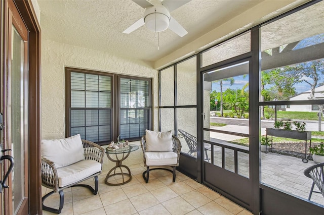 sunroom / solarium with a ceiling fan