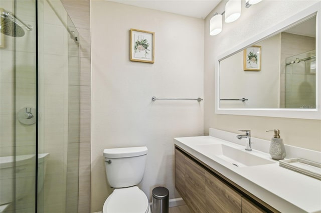 bathroom featuring vanity, toilet, and a stall shower