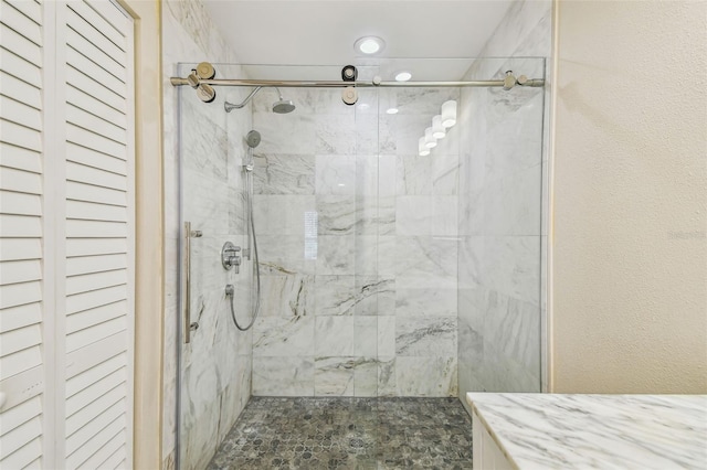 full bathroom featuring a stall shower and a textured wall