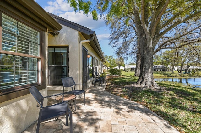 view of patio featuring a water view