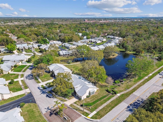 aerial view with a view of trees, a water view, and a residential view