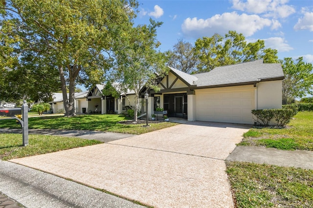 view of front facade with concrete driveway, a garage, a shingled roof, a front yard, and stucco siding