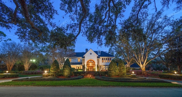 view of front of property featuring a front lawn and a chimney