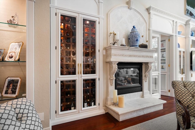 living room with dark wood-style floors and a glass covered fireplace