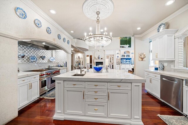 kitchen featuring dark wood-style floors, appliances with stainless steel finishes, white cabinetry, and crown molding