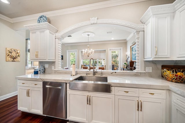 kitchen with arched walkways, a sink, white cabinetry, and dishwasher