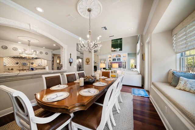 dining space featuring recessed lighting, a notable chandelier, wood finished floors, visible vents, and crown molding