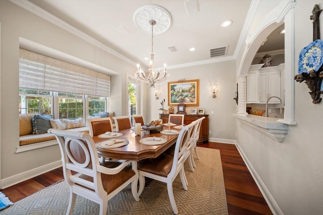 dining room featuring baseboards, visible vents, dark wood finished floors, and ornamental molding