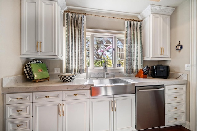 kitchen with dishwasher, a sink, and white cabinetry