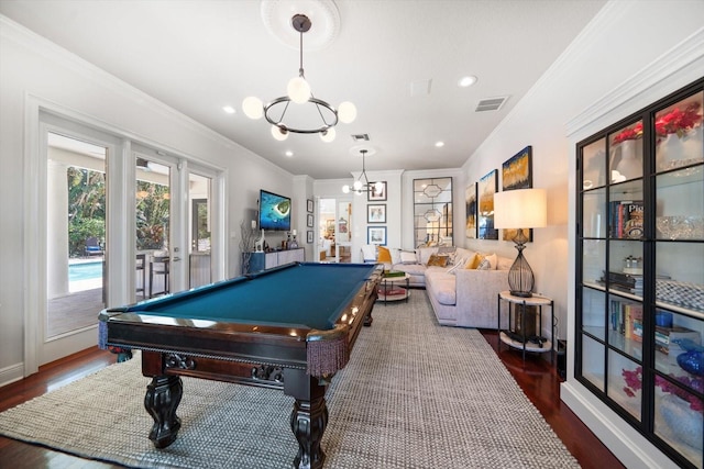 playroom featuring ornamental molding, wood finished floors, visible vents, and a notable chandelier