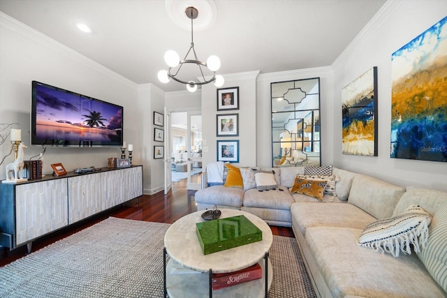 living room featuring ornamental molding, a notable chandelier, baseboards, and wood finished floors