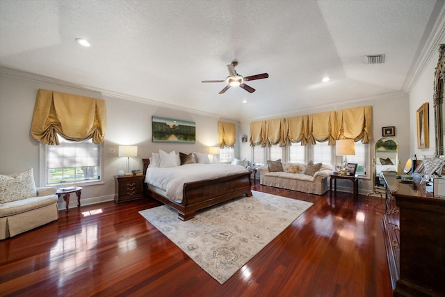 bedroom with crown molding, dark wood finished floors, a textured ceiling, and baseboards