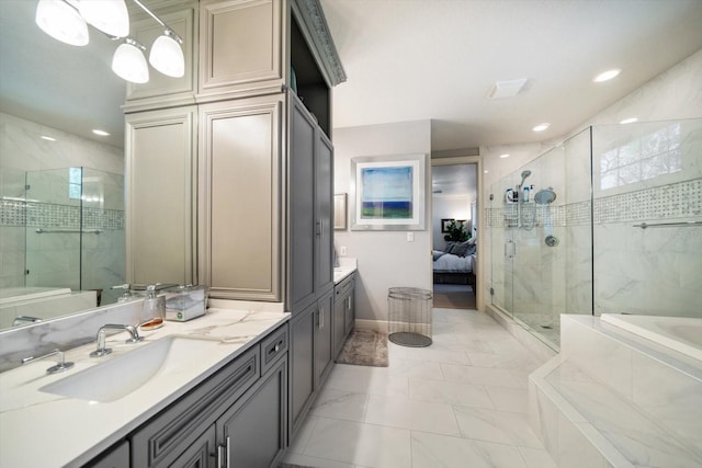 ensuite bathroom with ensuite bathroom, vanity, a shower stall, and a bath