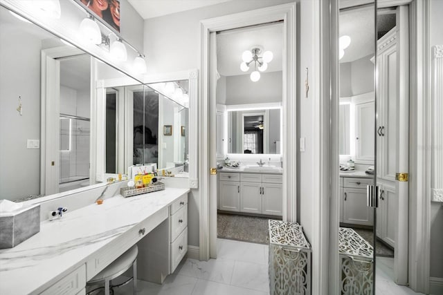 full bath with marble finish floor, a shower with door, and vanity