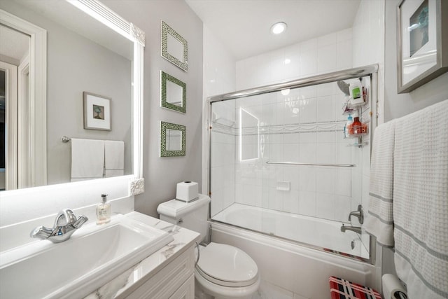 full bathroom with vanity, toilet, and bath / shower combo with glass door