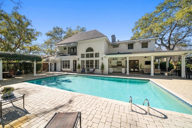 pool featuring french doors, outdoor lounge area, a patio, and ceiling fan