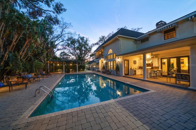 pool featuring a patio and outdoor dry bar