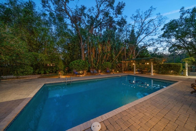 outdoor pool with a patio area