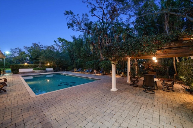 view of swimming pool featuring a fenced in pool, a patio, and a pergola