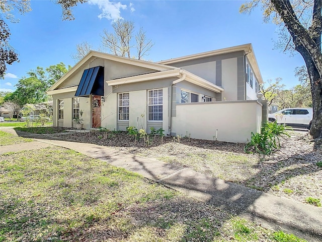 view of front of house featuring fence and stucco siding