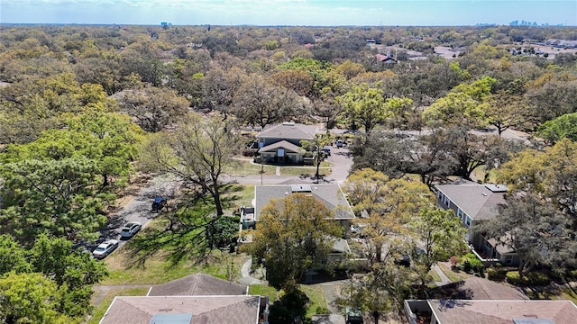 bird's eye view with a wooded view