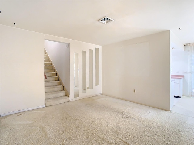 unfurnished room with stairway, carpet, and visible vents