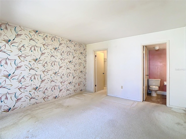 unfurnished room with carpet flooring and baseboards