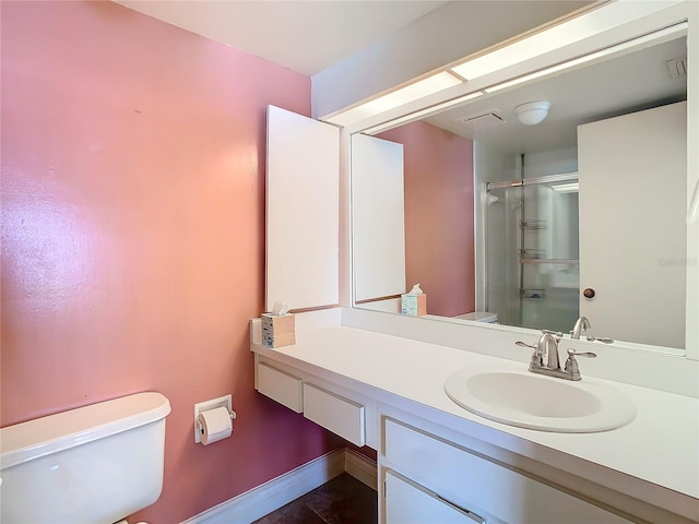 full bathroom featuring baseboards, vanity, toilet, and an enclosed shower