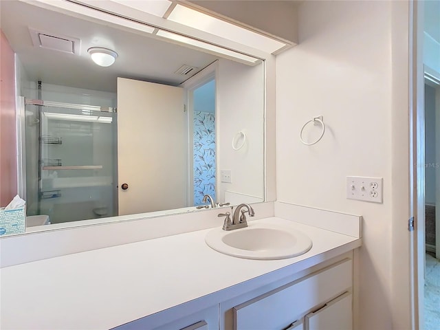 bathroom with toilet, a shower with door, visible vents, and vanity