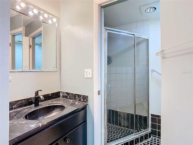 bathroom featuring a shower stall and vanity