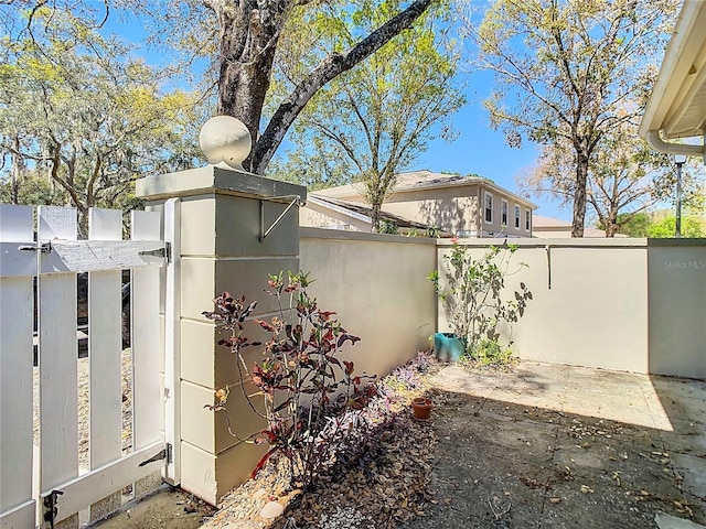 view of yard with a patio, fence private yard, and a gate