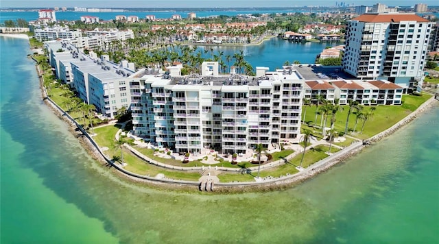 birds eye view of property with a water view, a beach view, and a city view