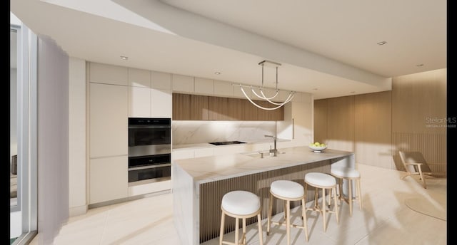 kitchen featuring light tile patterned floors, a sink, light countertops, multiple ovens, and modern cabinets