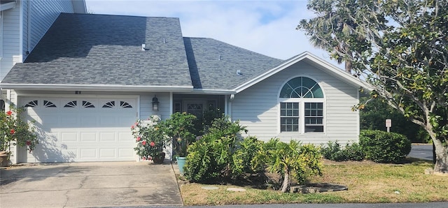 single story home featuring a garage, concrete driveway, and a shingled roof