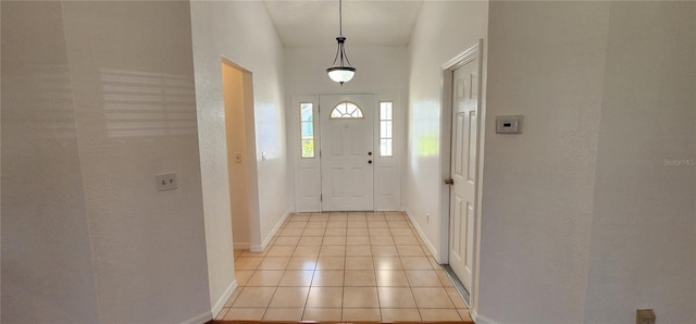 11722 Currie Ln Unit E1, Largo, FL 33774 - foyer entrance with baseboards and light tile patterned flooring