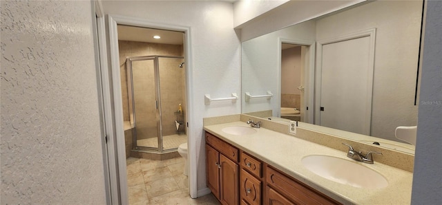 11722 Currie Ln Unit E1, Largo, FL 33774 - bathroom featuring toilet, a shower stall, double vanity, and tile patterned floors
