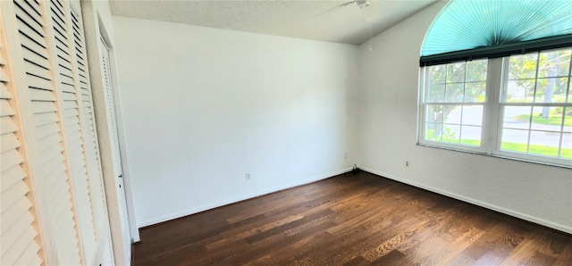 11722 Currie Ln Unit E1, Largo, FL 33774 - unfurnished bedroom with baseboards and dark wood finished floors
