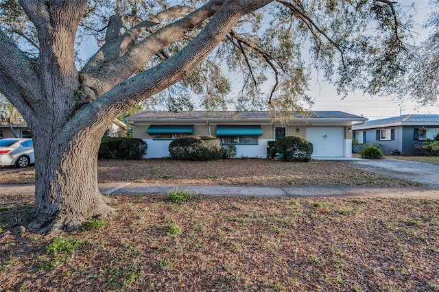 ranch-style home with driveway, brick siding, and an attached garage