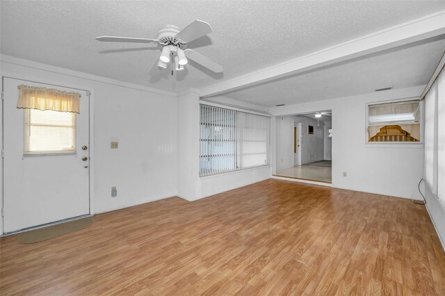 unfurnished living room with light wood-type flooring, ceiling fan, and a textured ceiling