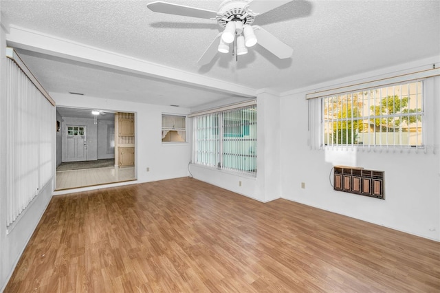 unfurnished living room featuring ceiling fan, a textured ceiling, and wood finished floors